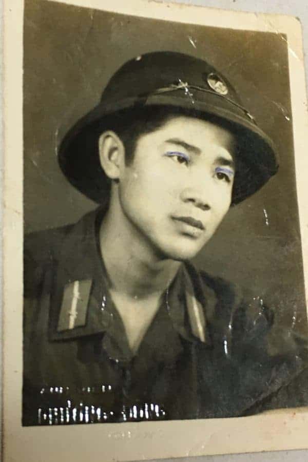 Photograph of North Vietnamese Army Infantry Corporal with a Viet Cong Two Color Sun Helmet Badge